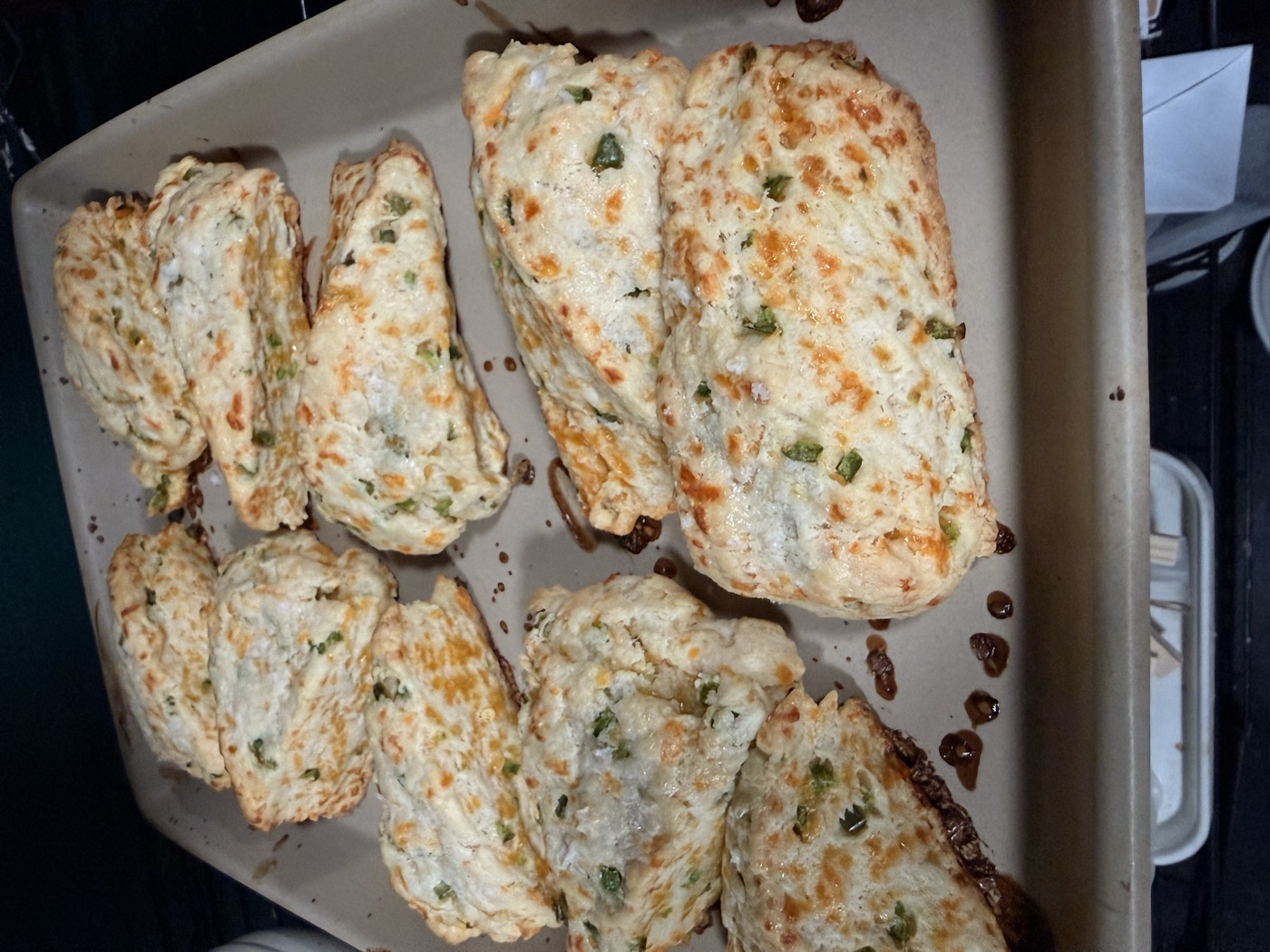 Tray of cheddar jalapeño scones baked golden and studded with peppers