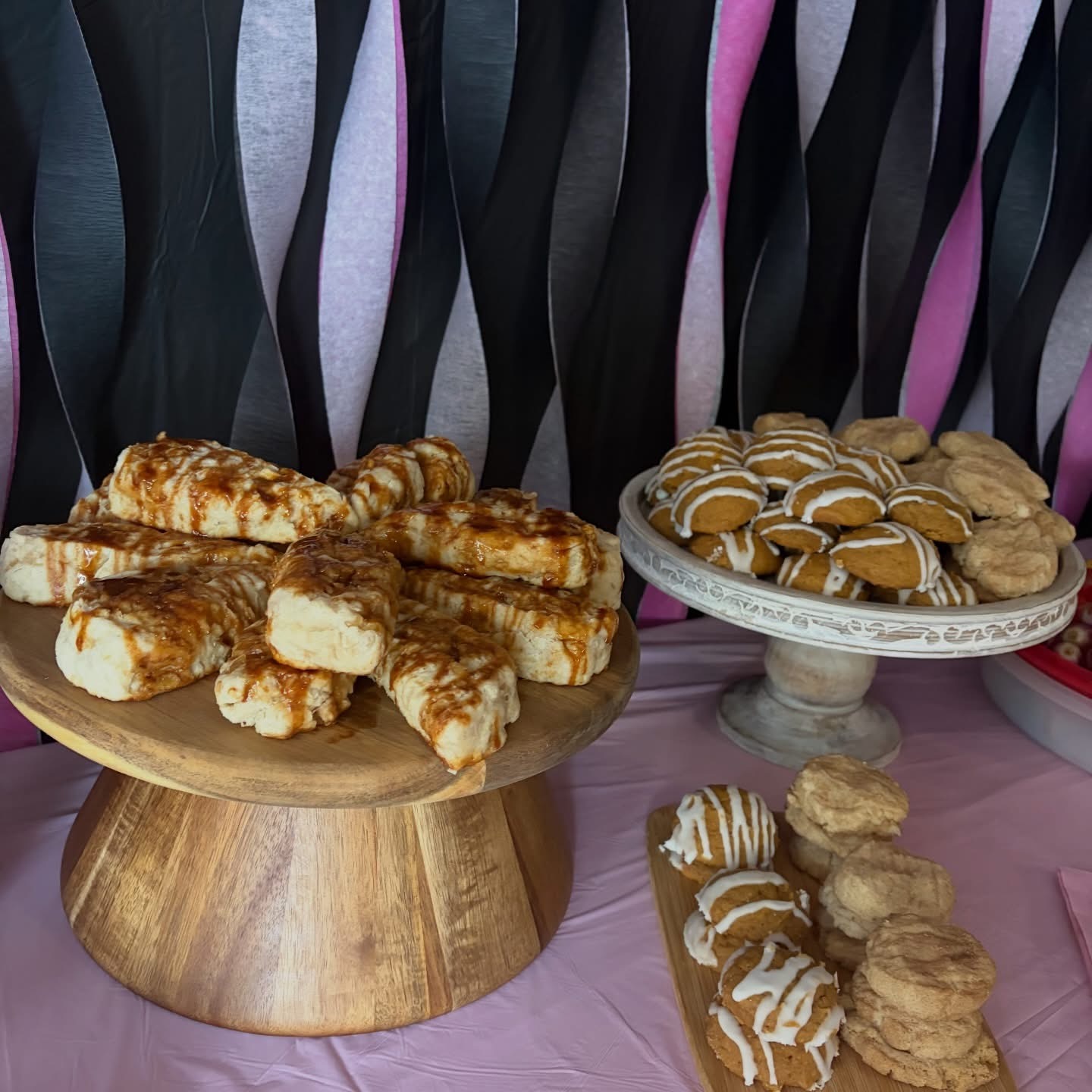 Dessert table spread with scones and iced cookies