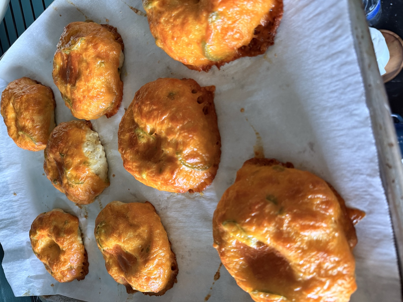 Jalapeño cheddar bagels baked deep golden on parchment
