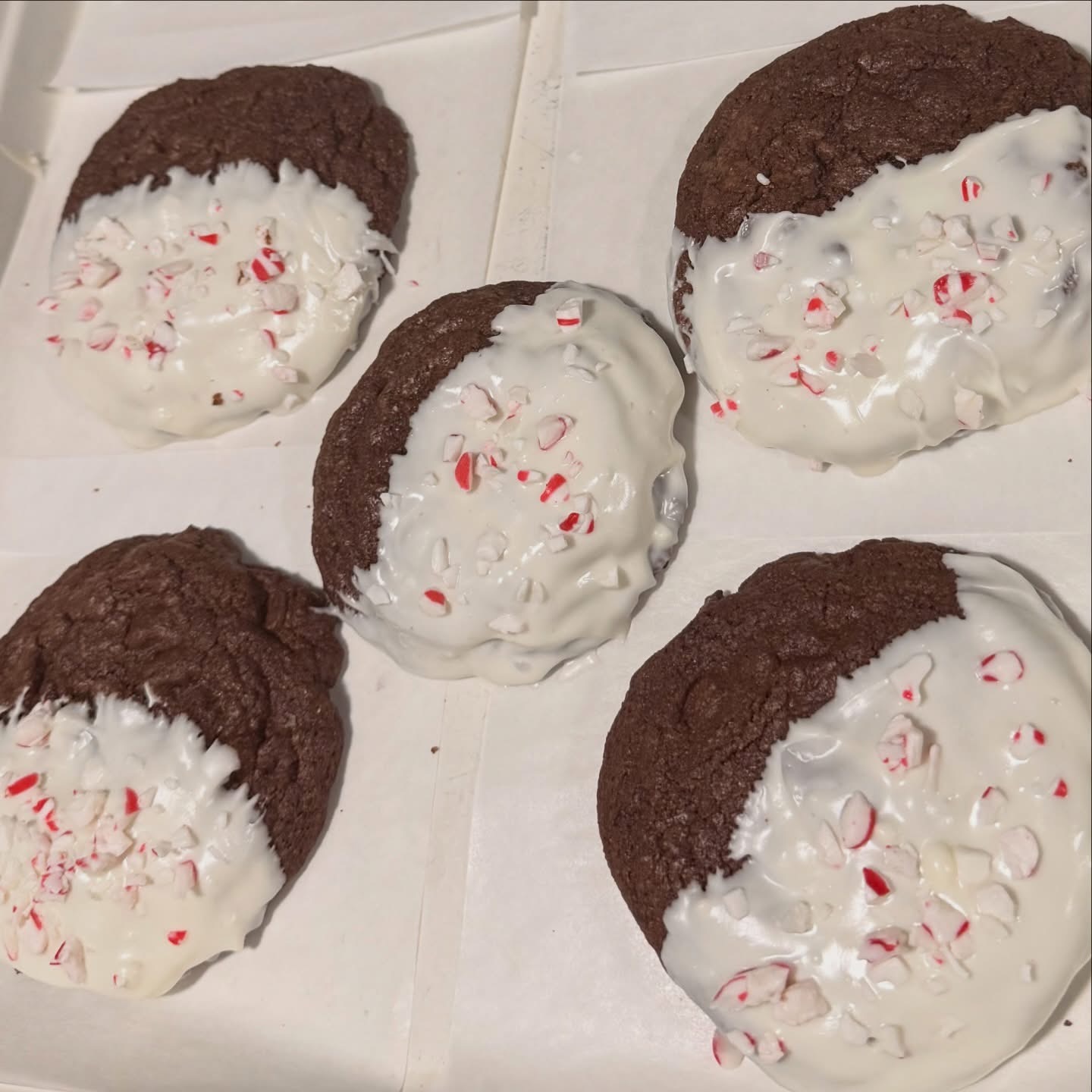 Chocolate cookies dipped in white chocolate with crushed peppermint